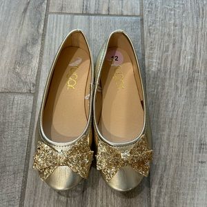 Gold bow slip on shoes